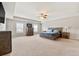 This main bedroom features carpet floors, ceiling fan, and a tray ceiling at 1695 Beckworth Ln, Hampton, GA 30228