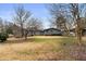 Backyard view of the house featuring a large lawn, shed and carport at 2533 Schooner Cv, Snellville, GA 30078