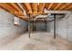 Large basement with concrete walls, duct work and metal support columns at 2533 Schooner Cv, Snellville, GA 30078