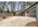 View of a house with a driveway and covered carport in the backyard at 2533 Schooner Cv, Snellville, GA 30078