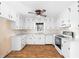 Bright kitchen with white cabinets, matching appliances, and ample counter space for cooking and storage at 2533 Schooner Cv, Snellville, GA 30078