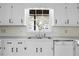 Close-up view of the sink and countertop area, highlighting the white cabinets and well-maintained appliances at 2533 Schooner Cv, Snellville, GA 30078