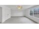 Bright bedroom featuring neutral carpeting, a ceiling fan, and a large window with natural light at 324 Cheri Pl, Jonesboro, GA 30238