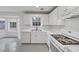 Modern all-white kitchen with stainless steel appliances and a view of the backyard at 324 Cheri Pl, Jonesboro, GA 30238