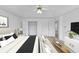 Staged main bedroom featuring a neutral color palette, ceiling fan, and sitting area at 324 Cheri Pl, Jonesboro, GA 30238