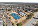 Panoramic aerial view showcasing the community's tennis courts, pool, clubhouse, and residential area at 4445 Trilogy Park Trl, Hoschton, GA 30548