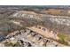 Wide aerial view of a residential community near a highway, highlighting the neighborhood's layout and proximity to amenities at 4445 Trilogy Park Trl, Hoschton, GA 30548