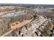 An aerial view shows new homes in a suburban community with plenty of trees at 4445 Trilogy Park Trl, Hoschton, GA 30548