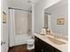 Cozy bathroom with a shower-tub combination and granite vanity at 4445 Trilogy Park Trl, Hoschton, GA 30548