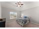 Cozy bedroom features a vaulted ceiling, ceiling fan, and window at 4445 Trilogy Park Trl, Hoschton, GA 30548