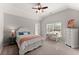 Cozy bedroom with vaulted ceiling features a ceiling fan and a work desk next to a window at 4445 Trilogy Park Trl, Hoschton, GA 30548