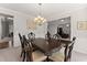 Dining room with a large dark table, neutral walls, and carpet at 4445 Trilogy Park Trl, Hoschton, GA 30548