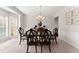 Elegant dining room with wainscoting, chandelier and neutral walls at 4445 Trilogy Park Trl, Hoschton, GA 30548