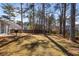 Large backyard with mature trees and a wooden fence at 4519 Legend Hollow Ln, Powder Springs, GA 30127