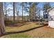 Spacious, grass-covered backyard with tall trees and a wooden fence at 4519 Legend Hollow Ln, Powder Springs, GA 30127