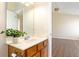 Bathroom vanity with wood cabinet and mirror, adjacent to a bedroom at 4519 Legend Hollow Ln, Powder Springs, GA 30127