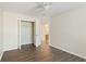 Bedroom features wood-look flooring, ceiling fan, and closet at 4519 Legend Hollow Ln, Powder Springs, GA 30127