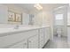 Double sink bathroom with white cabinets, white counters, and a view of the toilet at 500 Anfield Dr, Woodstock, GA 30188