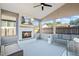 Cozy screened porch with fireplace, comfortable seating and a ceiling fan at 500 Anfield Dr, Woodstock, GA 30188