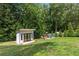 Backyard with a shed and playground equipment, perfect for enjoying the outdoors at 7010 Hunters Knl, Atlanta, GA 30328