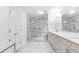 This elegant bathroom features a spacious walk-in shower with marble tile and a double vanity at 7010 Hunters Knl, Atlanta, GA 30328