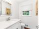 Clean and modern bathroom featuring a vanity with a mirror, toilet, and window at 7010 Hunters Knl, Atlanta, GA 30328