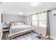 Bright bedroom featuring a plush bed, wood floors and natural light streaming through sheer curtains at 7010 Hunters Knl, Atlanta, GA 30328