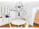 This dining area features a modern chandelier and easy access to both the kitchen and the staircase at 7010 Hunters Knl, Atlanta, GA 30328