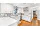 Bright kitchen features white cabinets, stainless steel appliances, and patterned backsplash, for a modern design at 7010 Hunters Knl, Atlanta, GA 30328