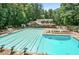 A community pool with lap lanes, lounge chairs, and picnic tables for residents to enjoy at 7010 Hunters Knl, Atlanta, GA 30328