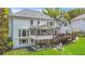 Rear exterior of a home featuring a deck, patio, screened in porch and well-maintained lawn at 7010 Hunters Knl, Atlanta, GA 30328