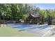 A community tennis court featuring a gazebo, landscaping, and lighting for evening play at 7010 Hunters Knl, Atlanta, GA 30328