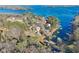 Beautiful aerial view of lakefront property with mature trees and private docks on a sunny day at 5065 Sunrise Ln, Cumming, GA 30041