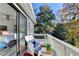 Relax on your private balcony with a view of trees and blue skies at 5065 Sunrise Ln, Cumming, GA 30041