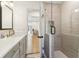 Modern bathroom featuring a glass-enclosed shower with white tile, a sleek vanity, and neutral decor at 5065 Sunrise Ln, Cumming, GA 30041