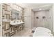 A uniquely designed bathroom with modern fixtures, a standalone shower, and a soaking tub at 5065 Sunrise Ln, Cumming, GA 30041