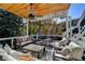 Outdoor covered patio with ample seating and an idyllic view of the wooded backyard at 5065 Sunrise Ln, Cumming, GA 30041