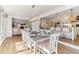 Well-lit dining room featuring hardwood floors, modern chandelier, and seamless access to the kitchen and living spaces at 5065 Sunrise Ln, Cumming, GA 30041