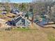 Charming two-story home featuring a deck and views of the lake, nestled on a grassy lot with mature trees at 5065 Sunrise Ln, Cumming, GA 30041