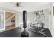 Fully equipped home gym with plenty of natural light and black flooring at 5065 Sunrise Ln, Cumming, GA 30041