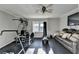 This home gym is equipped with exercise equipment and a cozy couch at 5065 Sunrise Ln, Cumming, GA 30041