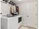 A practical laundry room equipped with modern washer and dryer units and ample storage at 5065 Sunrise Ln, Cumming, GA 30041