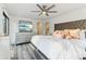 Spacious main bedroom with a large bed, dresser with a TV, and windows that flood the room with light at 5065 Sunrise Ln, Cumming, GA 30041