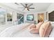 Bright main bedroom with ceiling fan, large windows, and sliding door to private balcony at 5065 Sunrise Ln, Cumming, GA 30041