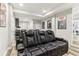 Home theater featuring plush seating, movie posters, and hardwood floors at 5065 Sunrise Ln, Cumming, GA 30041