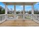 Balcony view framed by classic columns, showcasing neighborhood homes and tree-lined streets under a bright sky at 57 Moury Se Ave, Atlanta, GA 30315