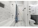 Bathroom featuring marble tile, a shower curtain, and modern fixtures at 57 Moury Se Ave, Atlanta, GA 30315