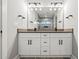 Bright bathroom boasts double sinks, stylish light fixtures, and a tiled walk-in shower at 57 Moury Se Ave, Atlanta, GA 30315