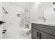 Stylish bathroom with marble-look tile, modern fixtures, and a sleek vanity and shower-tub combo at 57 Moury Se Ave, Atlanta, GA 30315
