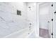 Clean bathroom featuring white marble tiles, a chrome shower head, and a closet at 57 Moury Se Ave, Atlanta, GA 30315